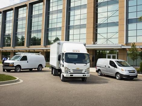 Commercial vehicle stands front of building
