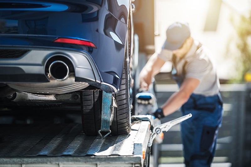 A mechanic servicing a car